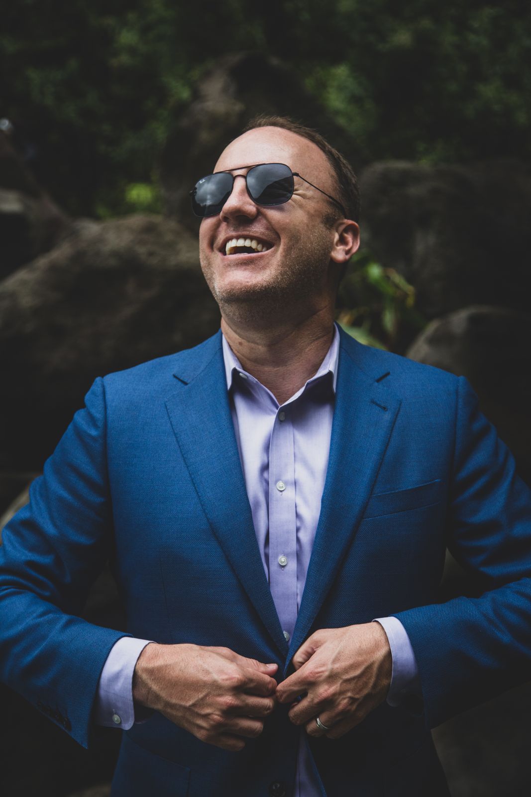 Darren Marble laughing, buttoning a blue blazer
